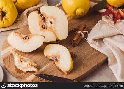 Ripe whole and sliced quinces. Fresh fruit for preparing recipes with cinnamon and lemon. An essential ingredient for a healthy diet