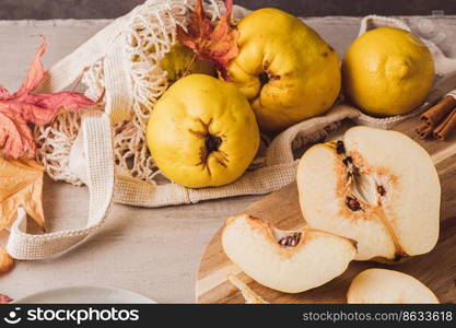 Ripe whole and sliced quinces. Fresh fruit for preparing recipes with cinnamon and lemon. An essential ingredient for a healthy diet