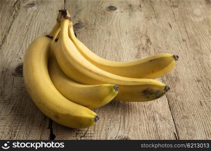 Ripe yellow bananas on old wooden boards