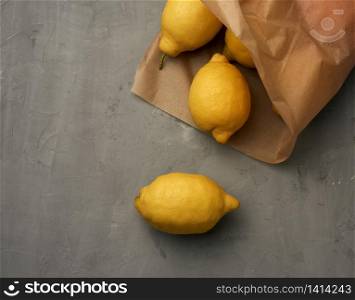 ripe yellow lemons on a gray table, ingredient for lemonade, top view