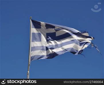 ripped flag of Greece against blue sky background