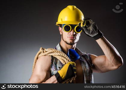 Ripped muscular builder man with tools