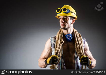 Ripped muscular builder man with tools