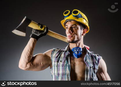 Ripped muscular builder man with tools