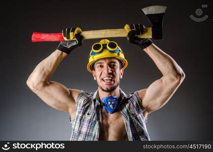 Ripped muscular builder man with tools