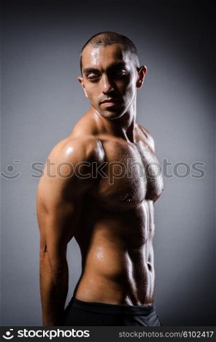 Ripped young man in bodybuilding concept