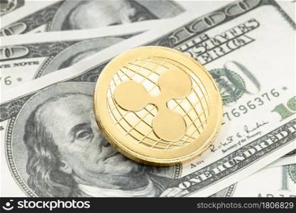 Ripple coin on dollar banknotes. XRP Cryptocurrency on US dollar bills