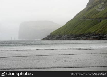 Risin and Kellingin rocks in the sea as seen from Tjornuvik bay on Streymoy on the Faroe Islands, Denmark, Europe