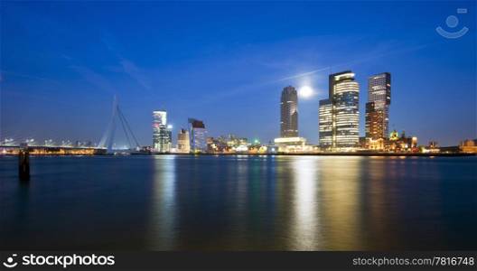 Rising moon over the Rotterdam Skyline