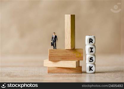 Risk business concept, business man stands on wooden blocks. risk control and managment idea