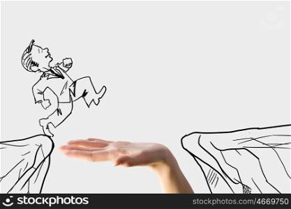 Risk in business. Human hand and caricature of businessman jumping above gap