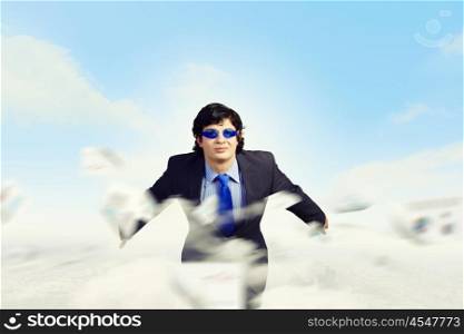 Risk in business. Image of young businessman in goggles jumping from top of building