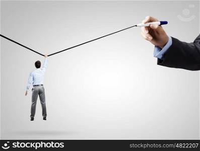 Risk in business. Rear view of businessman hanging on drawn line