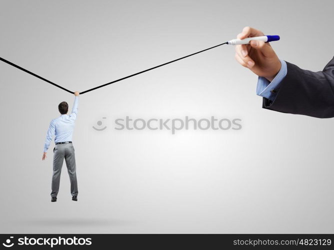 Risk in business. Rear view of businessman hanging on drawn line