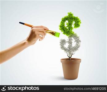Risk in investment. Close up image of human hand painting plant shaped like dollar sign