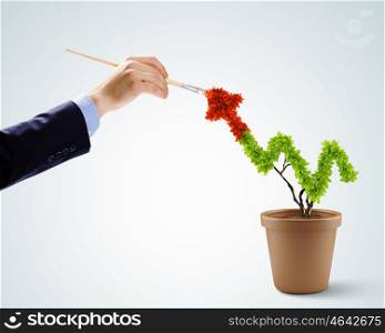 Risk in investment. Close up image of human hand painting plant shaped like graph