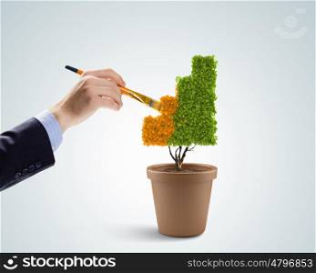 Risk in investment. Close up image of human hand painting plant shaped like graph