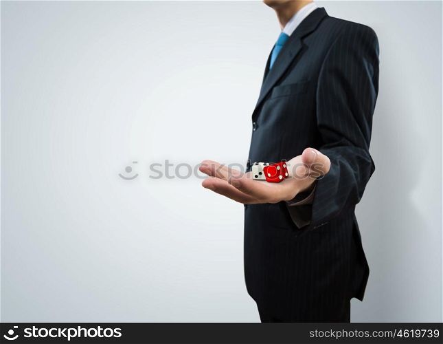 Risky business. Close up of businessman throwing dice. Gambling concept