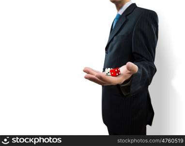 Risky business. Close up of businessman throwing dice. Gambling concept