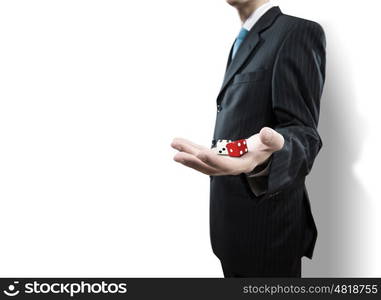 Risky business. Close up of businessman throwing dice. Gambling concept