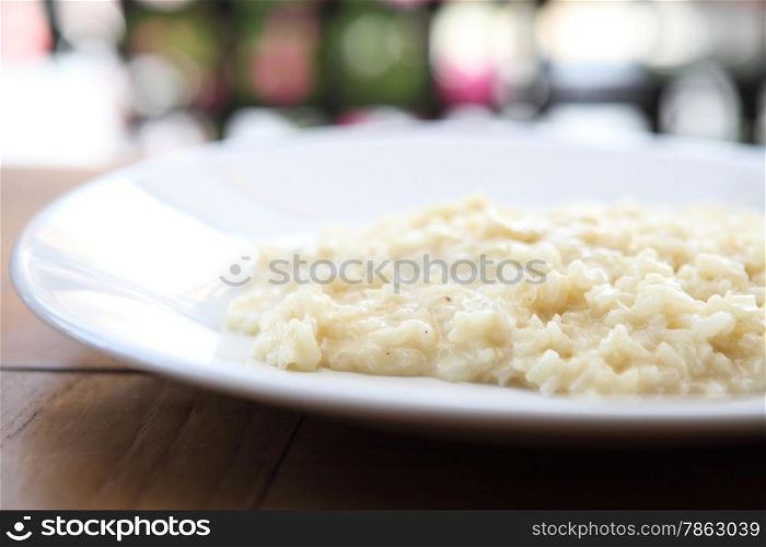 risotto dish with herbs on wood background