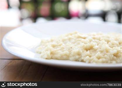 risotto dish with herbs on wood background