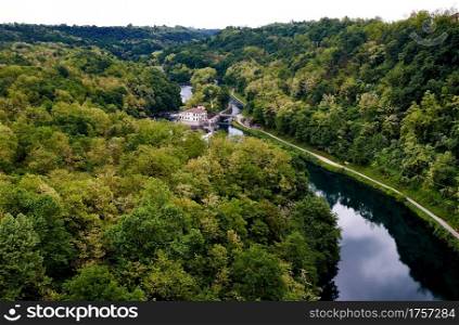 River Adda through a forest and a small house in Lomardi