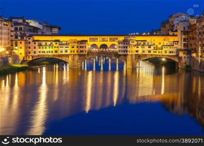 River Arno and famous bridge Ponte Vecchio at night from Ponte Santa Trinita in Florence, Tuscany, Italy