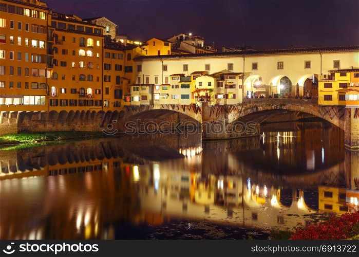 River Arno and Ponte Vecchio in Florence, Italy. River Arno and famous bridge Ponte Vecchio at night in Florence, Tuscany, Italy