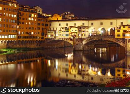 River Arno and Ponte Vecchio in Florence, Italy. River Arno and famous bridge Ponte Vecchio at night in Florence, Tuscany, Italy