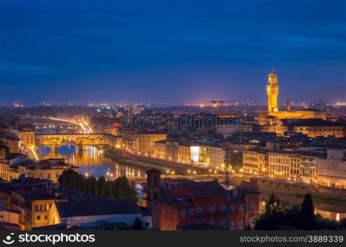 River Arno with bridge Ponte Vecchio and Palazzo Vecchio at night from Piazzale Michelangelo in Florence, Tuscany, Italy