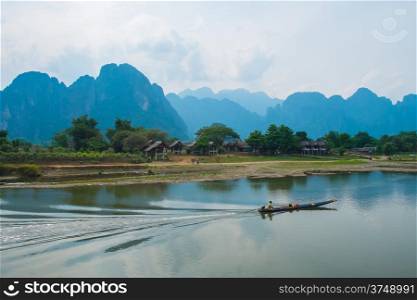River, boat, village and mountains landscape, Laos, Southeast Asia
