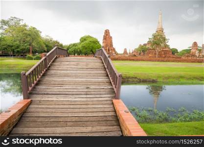 River bridge at Wat Mahathat temple Ayutthaya with Historical Park background, Thailand