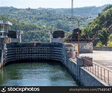 River cruise boat entering the lock of the Carrapatelo dam on River Douro. Entering Barragem do Carrapatelo dam and lock on the Douro river near Porto