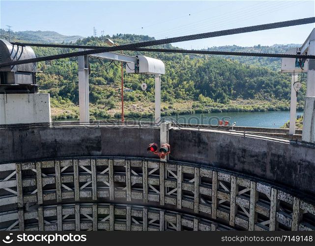 River cruise boat entering the lock of the Carrapatelo dam on River Douro. Entering Barragem do Carrapatelo dam and lock on the Douro river near Porto
