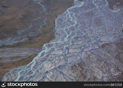 River delta with turquoise water in barren earth