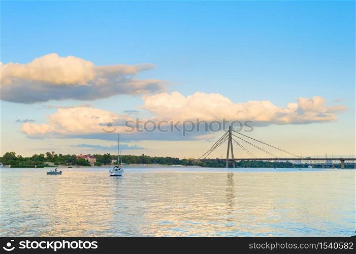River Dnieper, yacht and Pivnichnyi (Northern) Bridge. Kiev, Ukraine