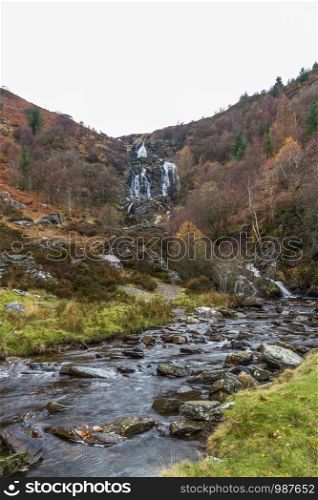 River Eiddew with Rhiwargor waterfall in the distance. Lake Vyrynwy, Powys, Wales UK, portrait, wide angle