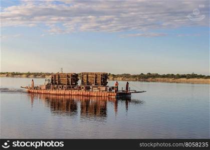 River ferry with timber on the Northern Dvina near Krasnoborsk, Russia. Sunset