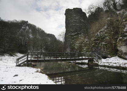 River flowing through snow covered Winter landscape in valley