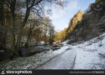 River flowing through snow covered Winter landscape in valley