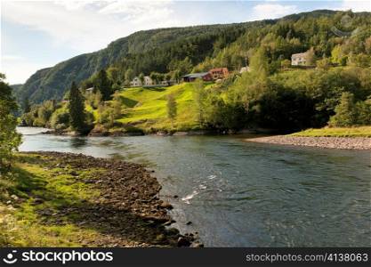 River flowing with village in the background, Norway