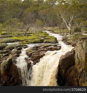 River flows through countryside on its way to Nigretta Falls in Western Victoria, Australia