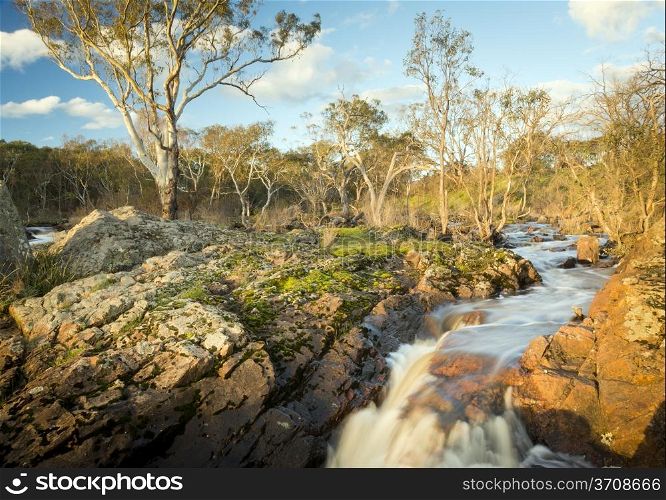 River flows through countryside on its way to Nigretta Falls in Western Victoria, Australia