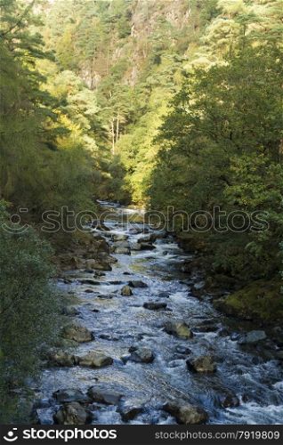 River Glaslyn running through alpine style valley. Beddgelert, Snowdonia, Gwynedd, Wales, United Kingdom.
