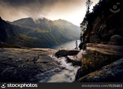 River in foggy mountains landscape. Nature in mountains.