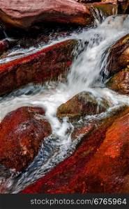 river stream flowing over rock formations in the mountains