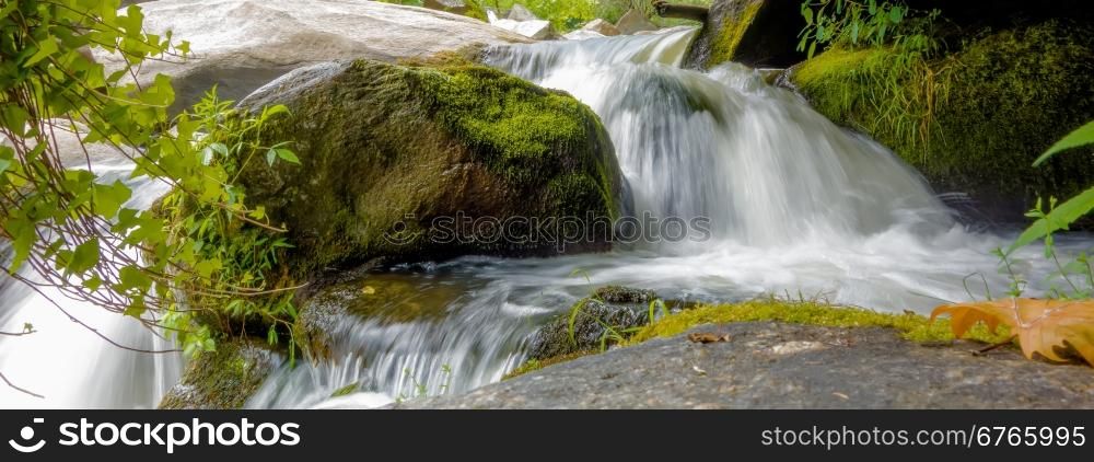 river stream flowing over rock formations in the mountains