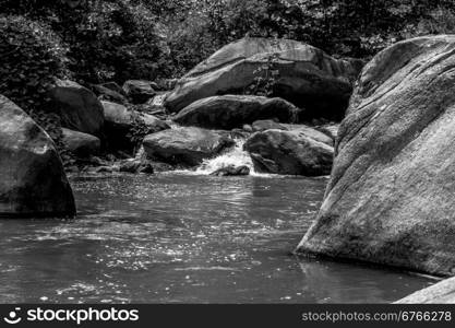 river stream flowing over rock formations in the mountains