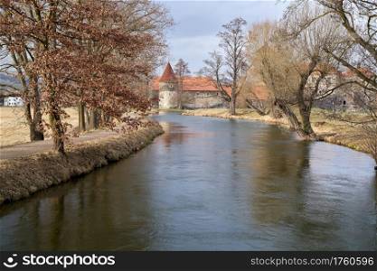 River with trees, with Svihov Castle near Klatovy in the Czech Republic in the background